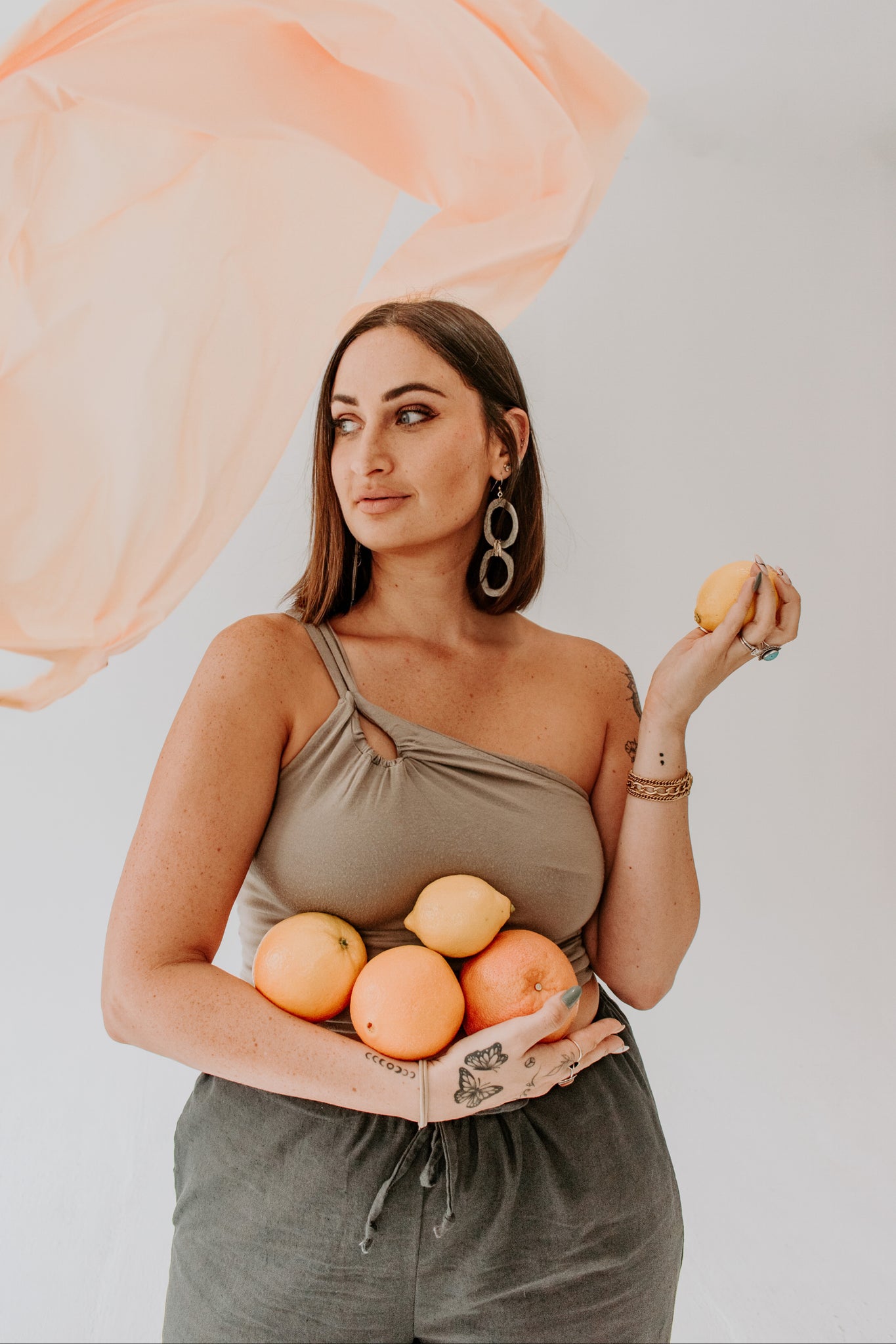 woman wearing tank top holding fruit