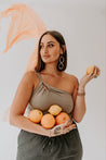 woman wearing earrings holding fruit