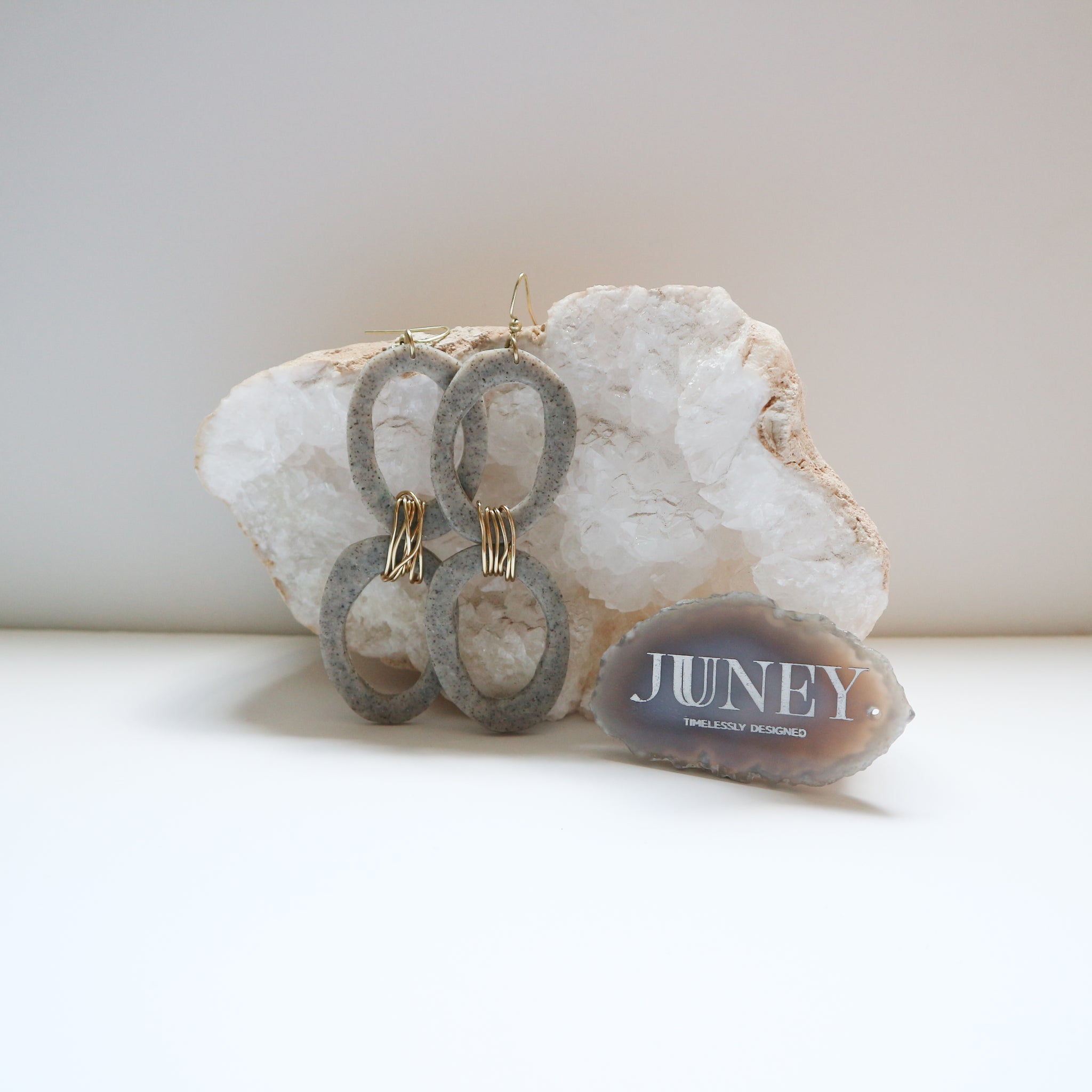 clay earrings hanging from crystal rock