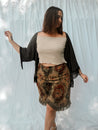 woman wearing charcoal cardigan with sand top and floral skirt