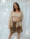 woman wearing cardigan with sand top and floral skirt