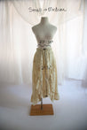 Mannequin wearing a lace skirt with measurements on a white background
