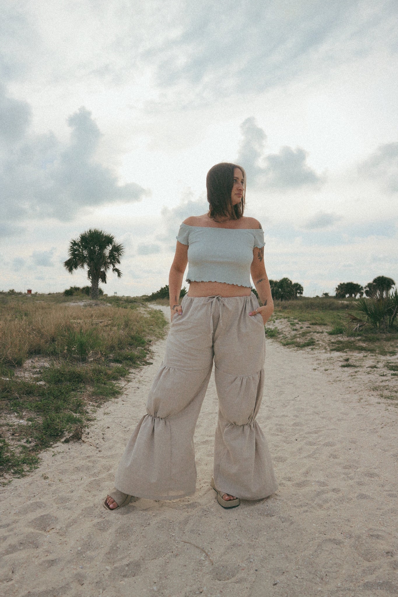 woman looking over shoulder in drawstring pants