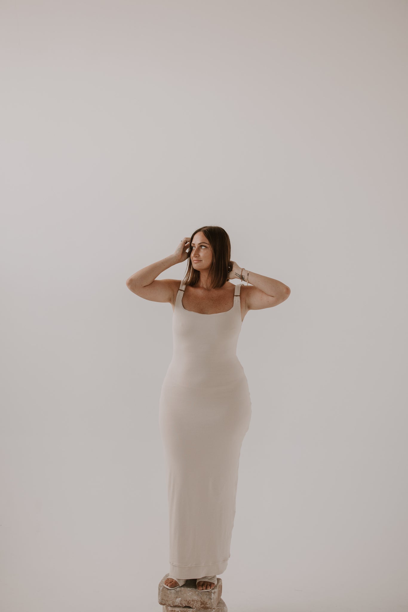 woman standing wearing light maxi dress